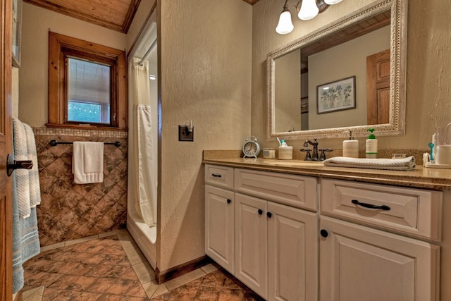 bathroom with crown molding, vanity, and curtained shower