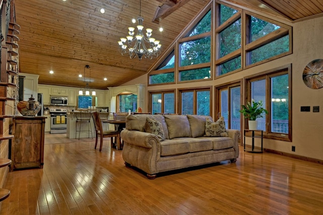 living room featuring high vaulted ceiling, wooden ceiling, light hardwood / wood-style flooring, and an inviting chandelier