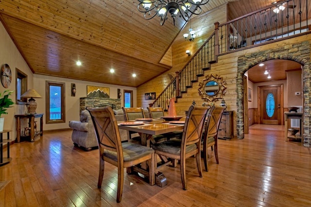 dining space featuring a notable chandelier, wood ceiling, hardwood / wood-style flooring, and high vaulted ceiling