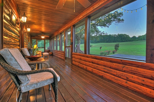 sunroom / solarium featuring ceiling fan and wood ceiling