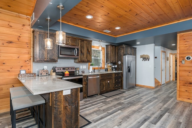 kitchen with kitchen peninsula, dark brown cabinets, wooden ceiling, and appliances with stainless steel finishes