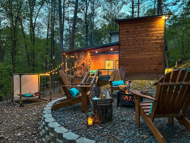 view of jungle gym with an outdoor fire pit