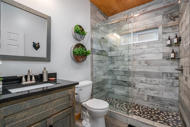 bathroom with vanity, toilet, a shower with shower door, and wood ceiling