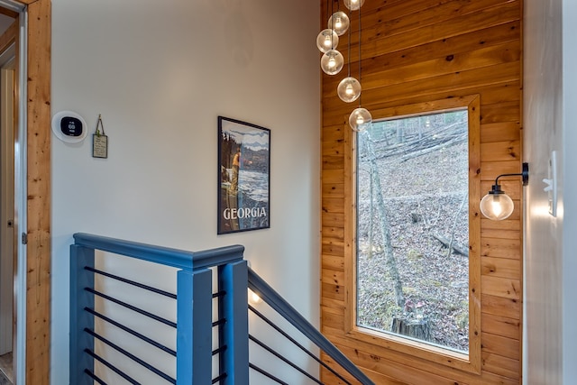 stairs featuring wooden walls