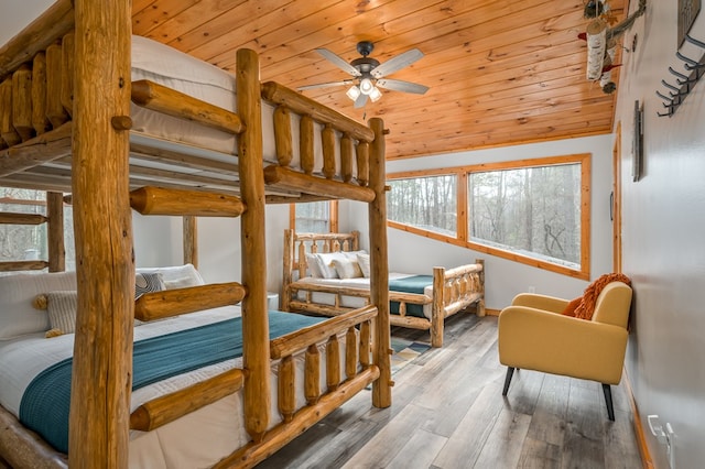 bedroom with ceiling fan, hardwood / wood-style floors, wood ceiling, and lofted ceiling