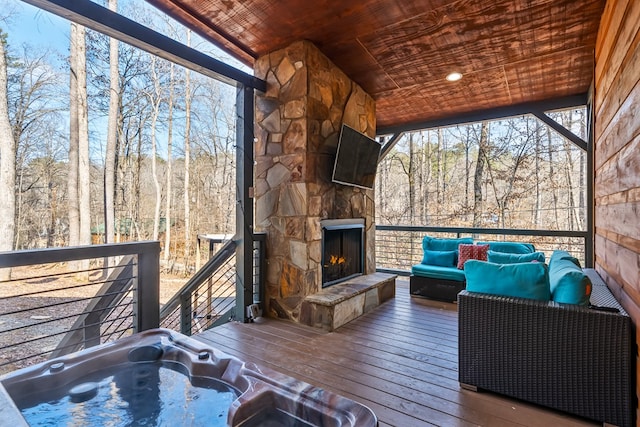 wooden deck with an outdoor living space with a fireplace