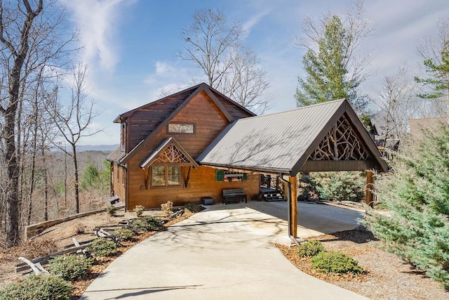 surrounding community with driveway and a carport