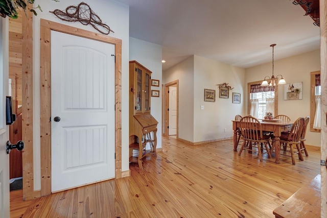 foyer featuring a notable chandelier and light hardwood / wood-style floors