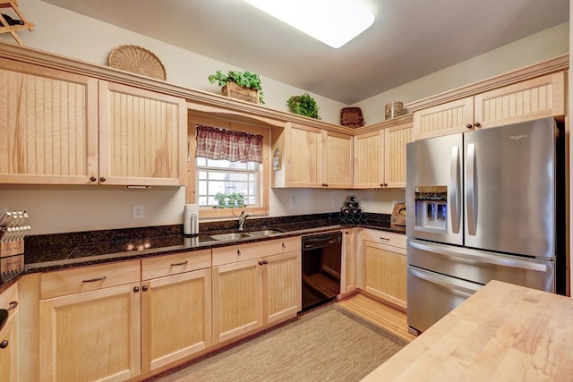 kitchen with dishwasher, stainless steel refrigerator with ice dispenser, light brown cabinetry, sink, and butcher block countertops