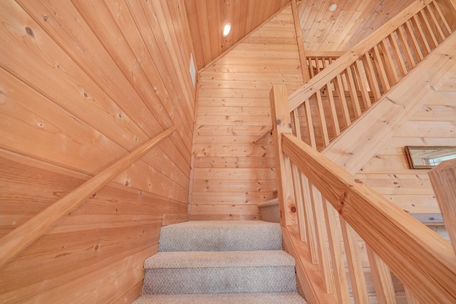 stairs featuring wood walls