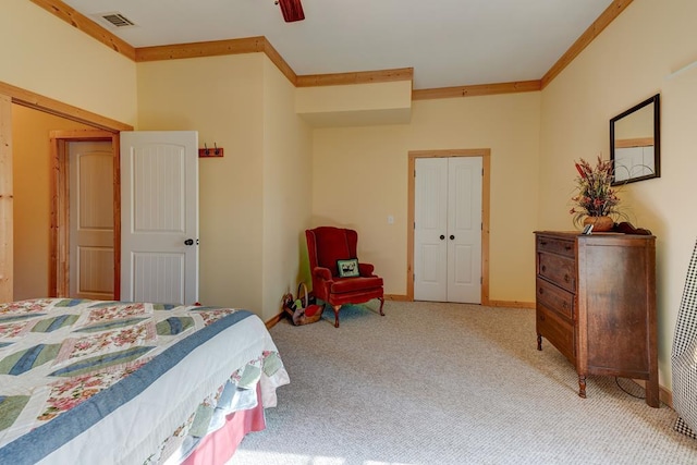 carpeted bedroom with ceiling fan, a closet, and ornamental molding