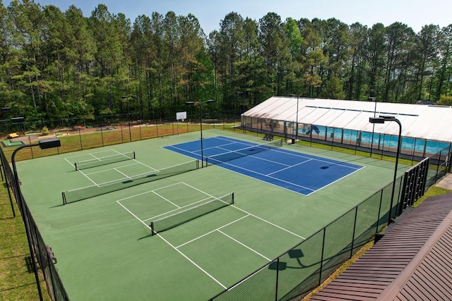 view of tennis court featuring basketball court