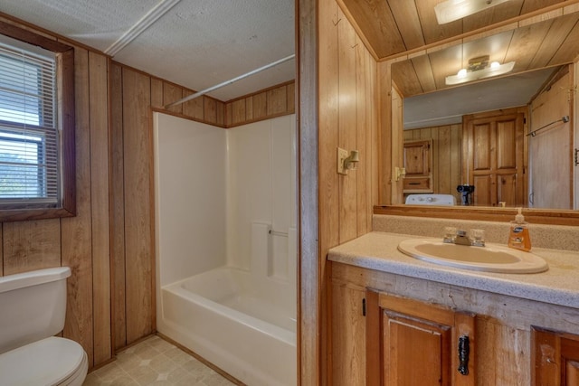 full bathroom with wooden walls, vanity, shower / bathtub combination, and toilet