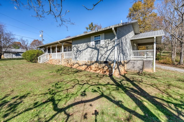 view of property exterior featuring a porch and a yard