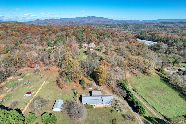 drone / aerial view featuring a view of trees and a mountain view