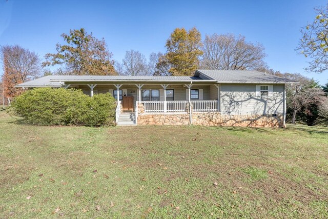 ranch-style house with covered porch, metal roof, and a front yard