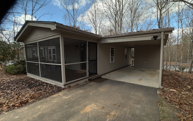 back of house featuring a carport