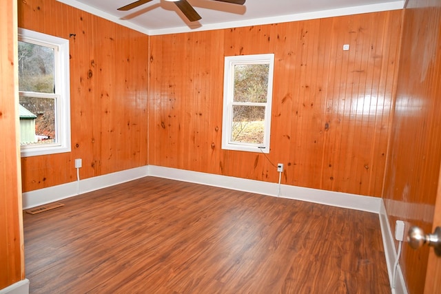 empty room featuring hardwood / wood-style flooring, ceiling fan, and crown molding