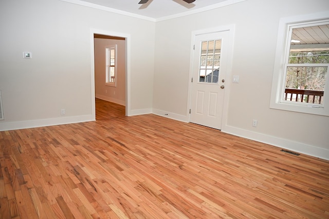 foyer featuring ceiling fan, crown molding, and light wood-type flooring