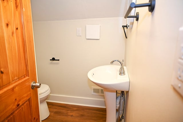 bathroom featuring sink, wood-type flooring, and toilet