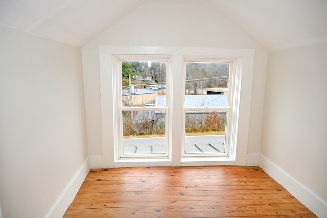 entryway with light hardwood / wood-style floors and vaulted ceiling