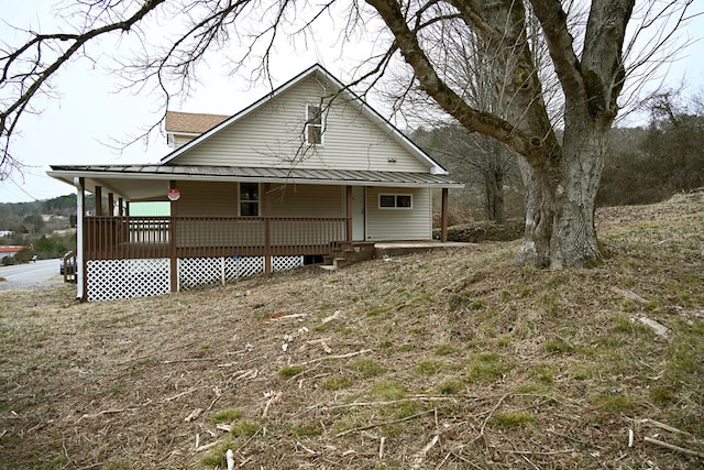 rear view of property featuring covered porch