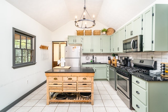 kitchen with a sink, decorative backsplash, appliances with stainless steel finishes, and light tile patterned floors