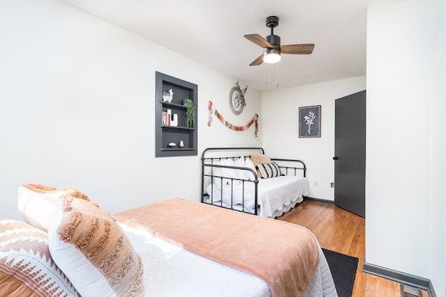 bedroom featuring a ceiling fan and wood finished floors