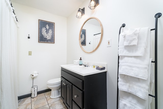 bathroom featuring baseboards, toilet, and vanity