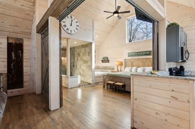 bedroom featuring wood ceiling, dark hardwood / wood-style flooring, wooden walls, ceiling fan, and high vaulted ceiling