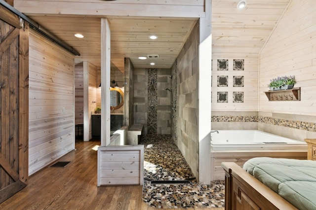 bathroom featuring vaulted ceiling, wooden walls, hardwood / wood-style flooring, a washtub, and wooden ceiling