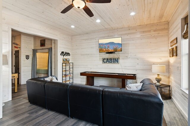 living room featuring hardwood / wood-style flooring, wooden ceiling, and wooden walls