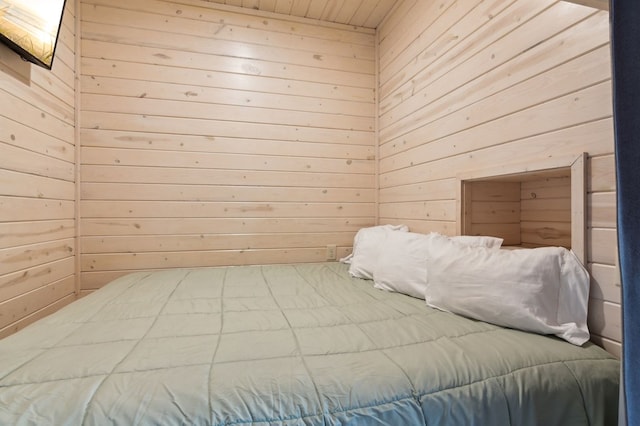 unfurnished bedroom with wood walls