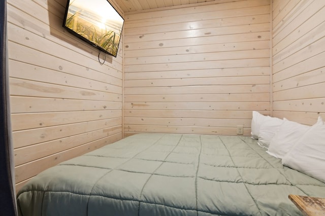 bedroom with wooden ceiling and wood walls