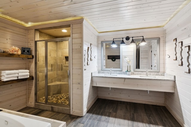 bathroom with a shower with shower door, wood-type flooring, wood walls, and wood ceiling