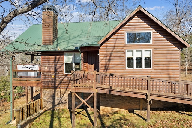 back of property with a wooden deck