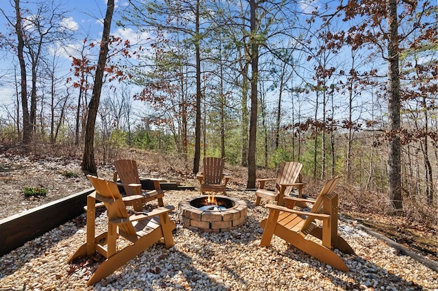 view of yard with a fire pit