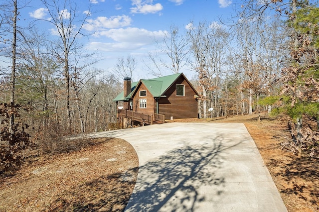 view of property exterior with a wooden deck