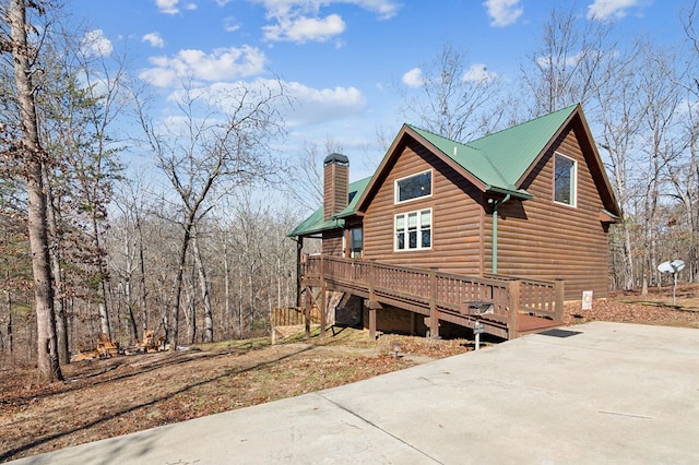 view of side of property with a wooden deck