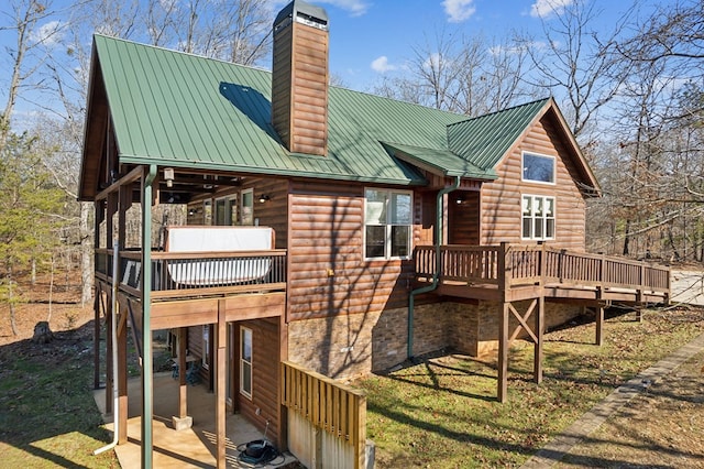 rear view of property featuring a deck