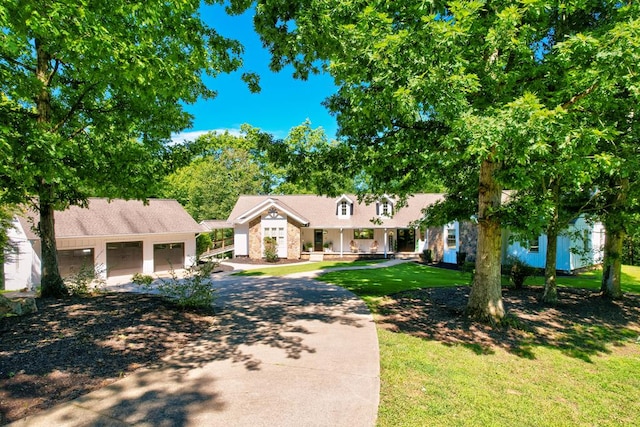 ranch-style house featuring a front yard and a garage