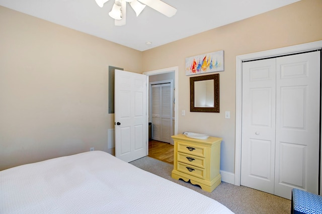 bedroom featuring light carpet, ceiling fan, and a closet