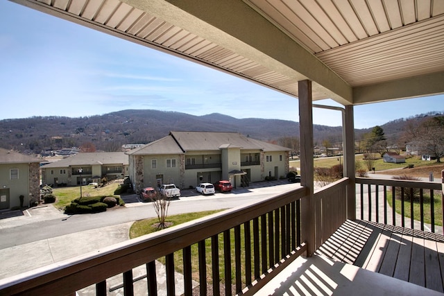 balcony featuring a residential view and a mountain view