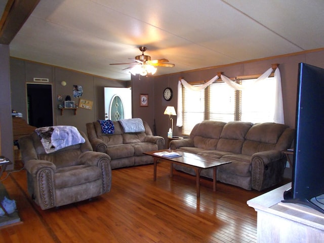 living room featuring visible vents, hardwood / wood-style flooring, and a ceiling fan
