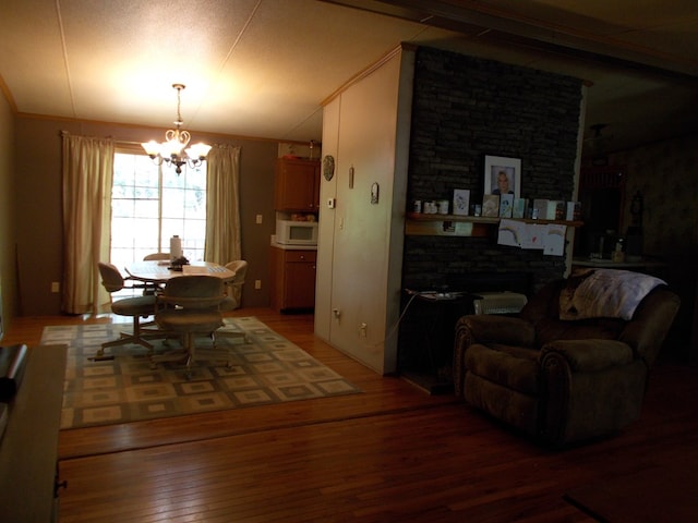 dining room featuring a chandelier, wood finished floors, and lofted ceiling