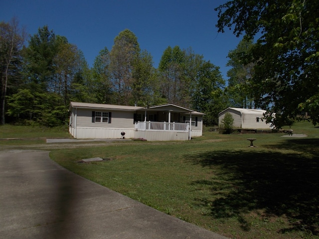 manufactured / mobile home with a front yard and a porch
