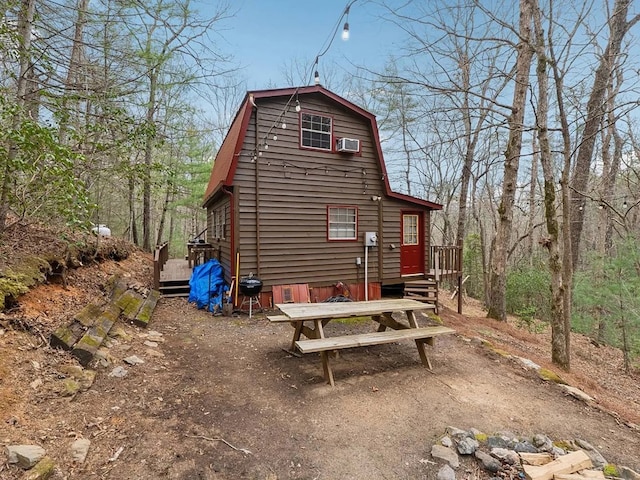 view of property exterior with a gambrel roof