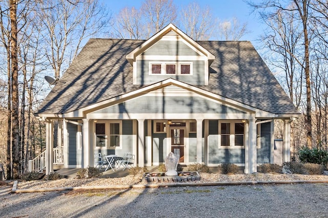 view of front of home featuring covered porch and roof with shingles