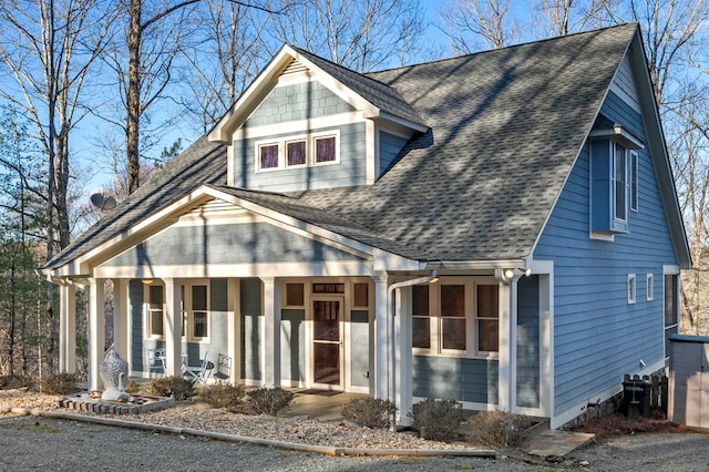 view of front of home with a shingled roof and a porch