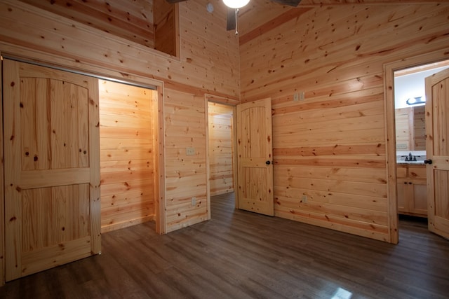 155 Stone Crest Ln, Murphy, NC 28906 - unfurnished bedroom with wood walls, dark wood-style floors, and connected bathroom
